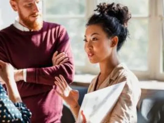 Woman presenting to a small group.