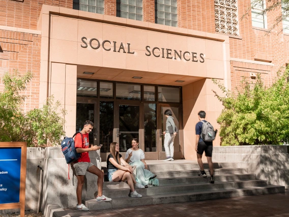 four students in front of the Social Sciences building